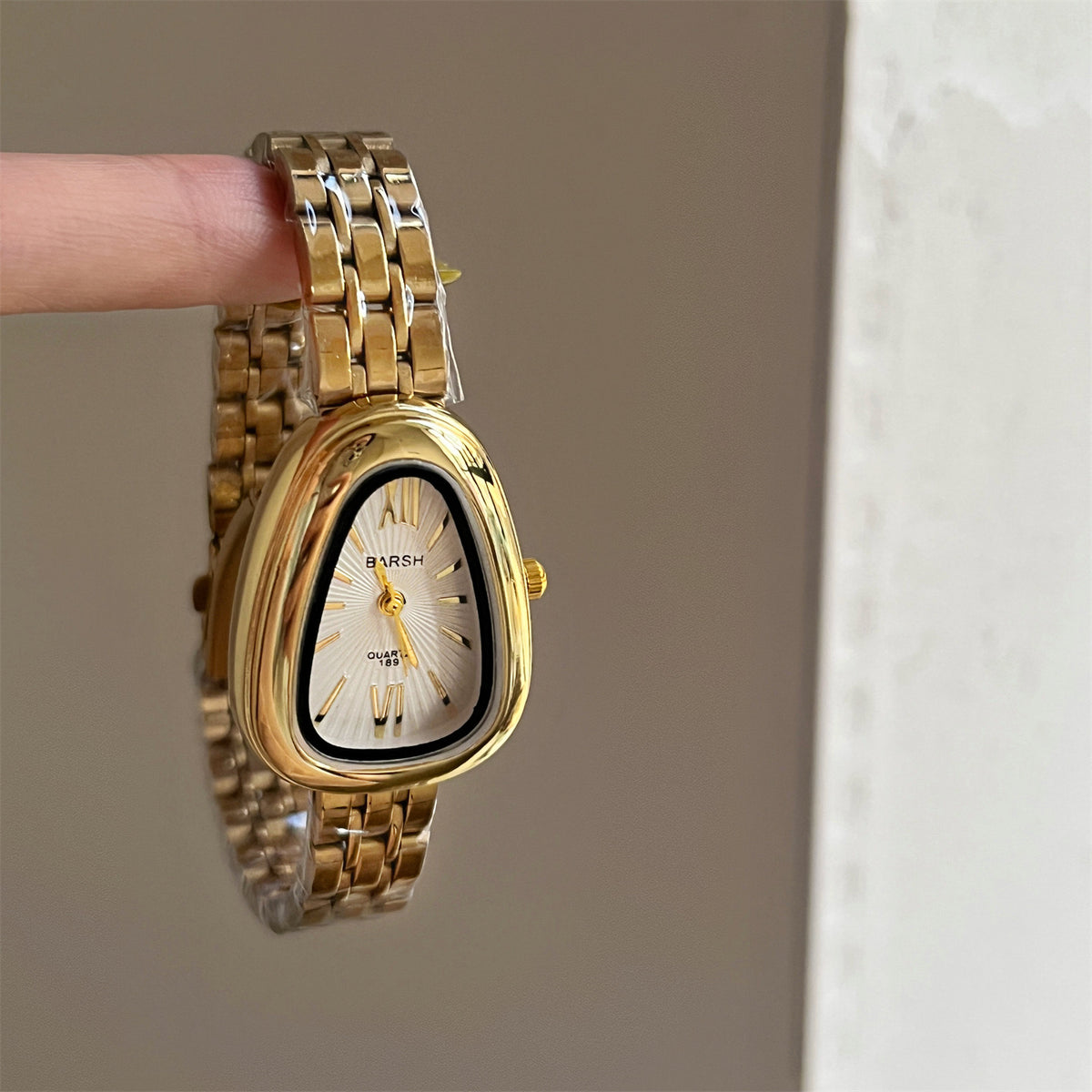 Reloj oval grueso irregular dorado con blanco