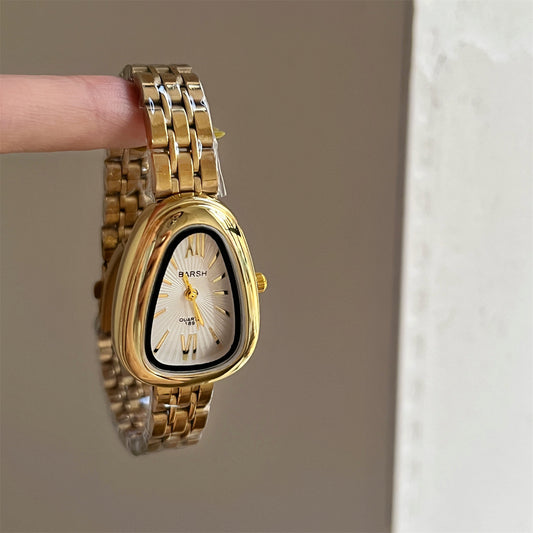 Reloj oval grueso irregular dorado con blanco