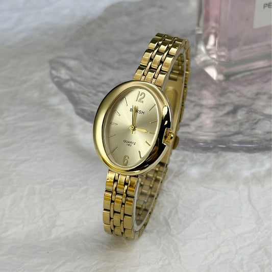 Reloj dorado oval contorno grueso