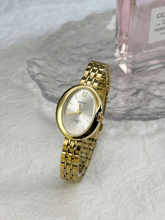 Reloj dorado oval contorno grueso blanco