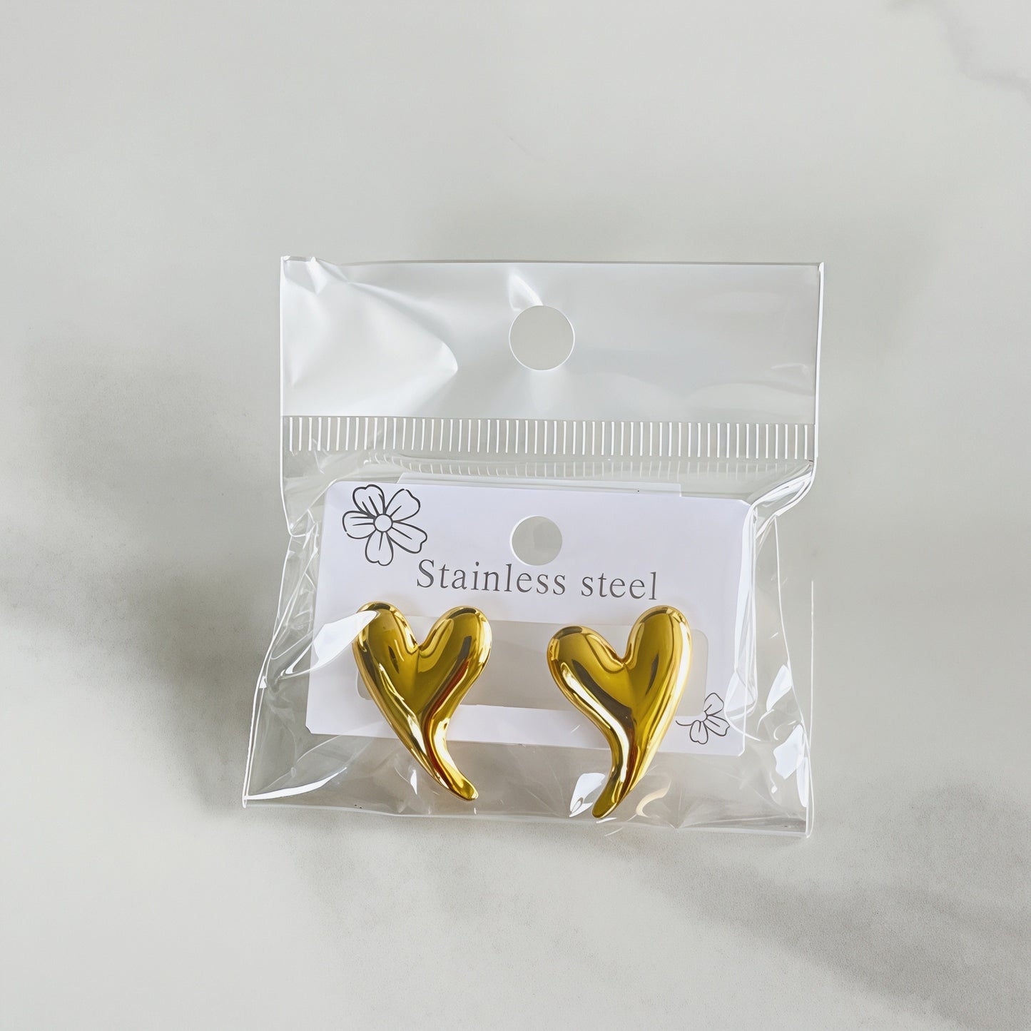 Aretes corazón con colita